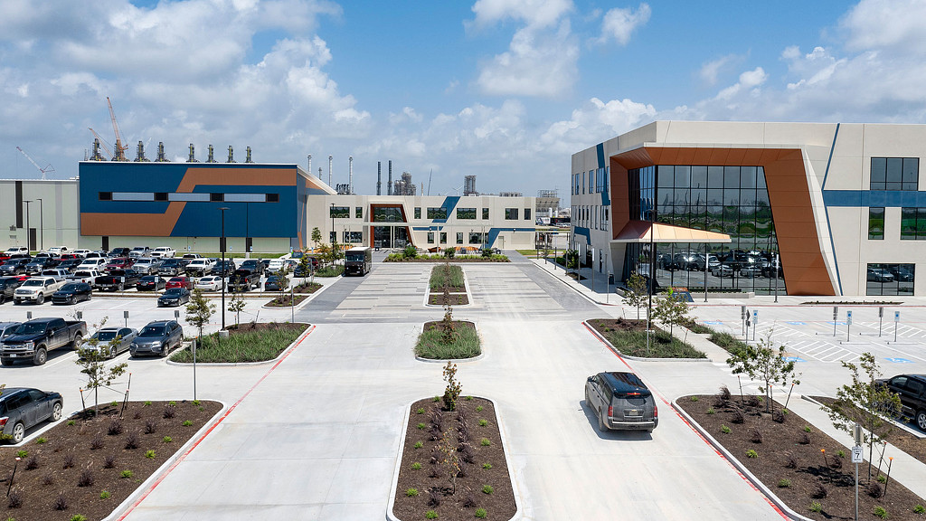 A parking lot with cars and buildings.
