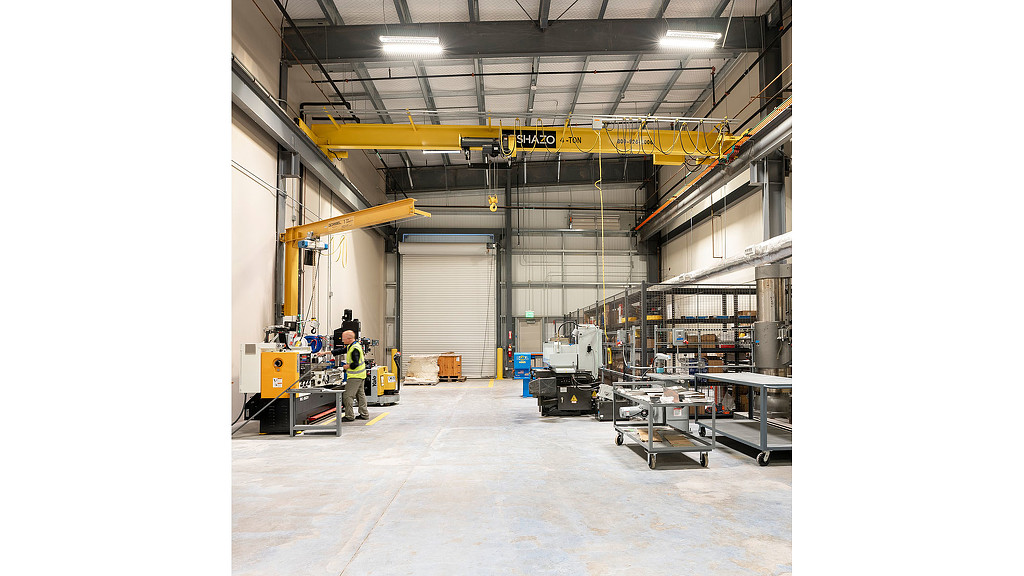 A person standing in a warehouse.