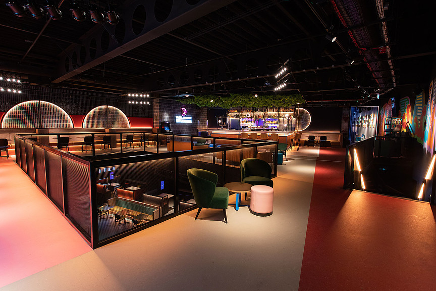 A room with a large screen and chairs.