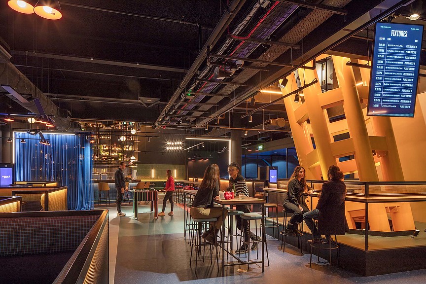 People sitting at tables in a building.