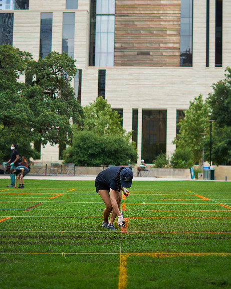 A person bending over on a field.