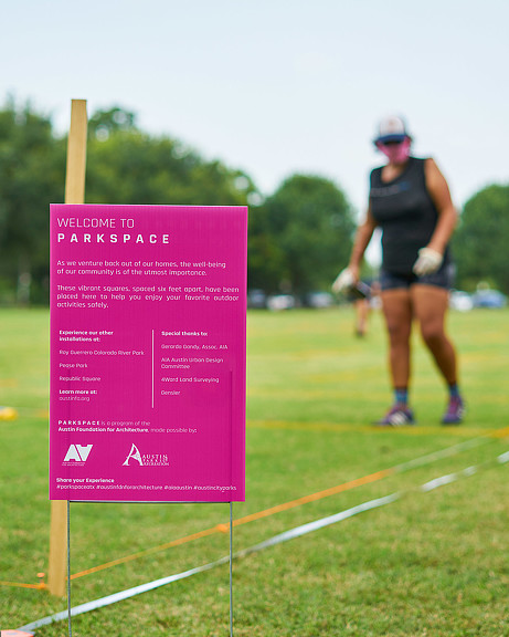 A person running on a grass field.