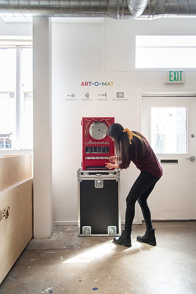 A man standing next to a machine.