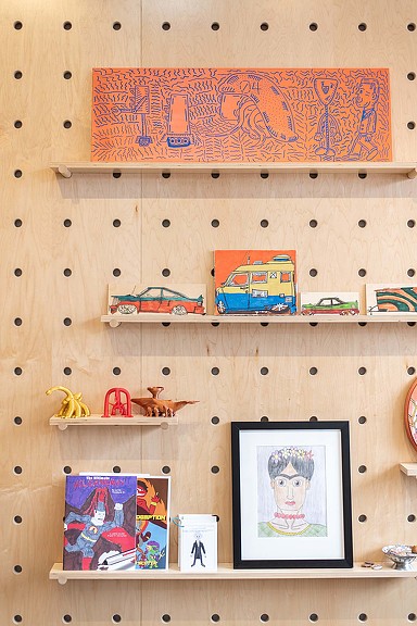 A shelf with pictures and pictures on it.