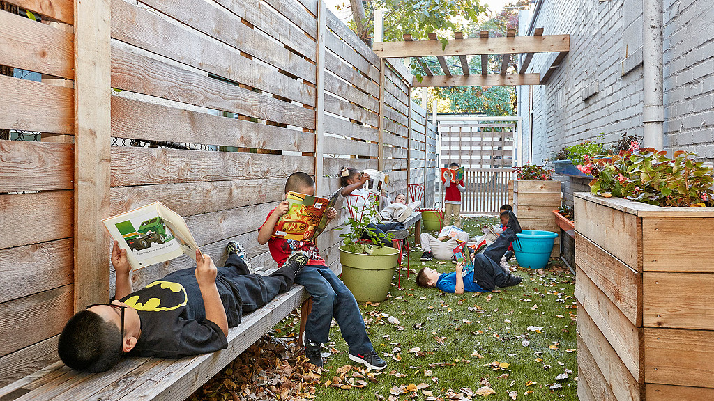 A group of people sitting on the grass.