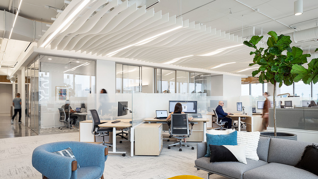 A room with a few people and computers.