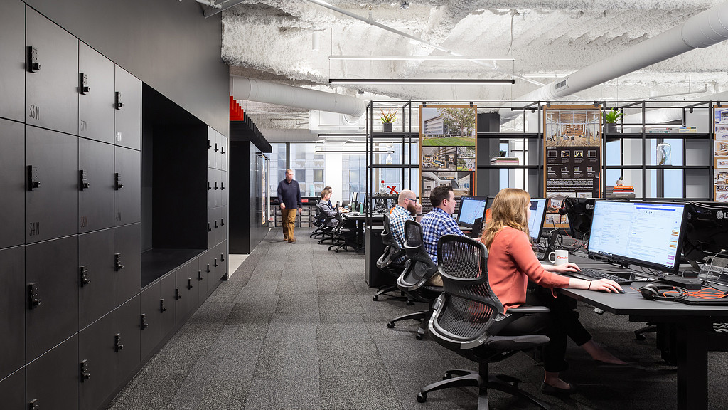 People sitting at computers in an office.
