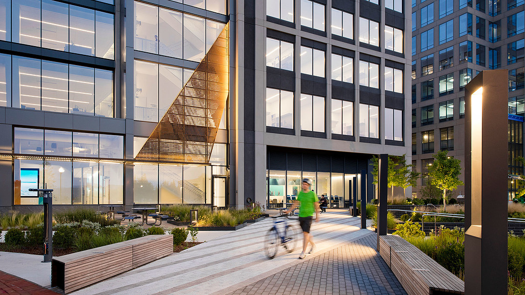 A person walking with a bicycle.