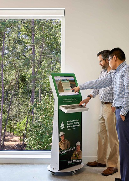 A man and woman looking at a display of a movie.