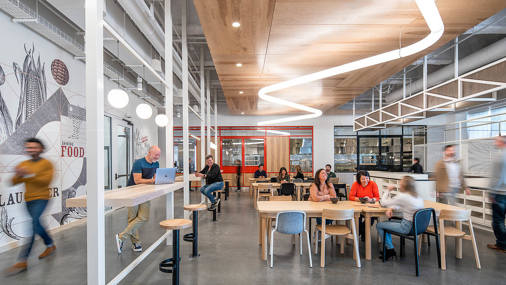 A group of people sitting at tables.