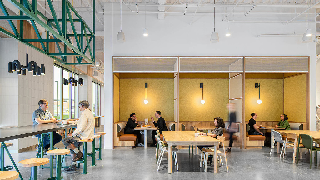 A group of people sitting at tables.