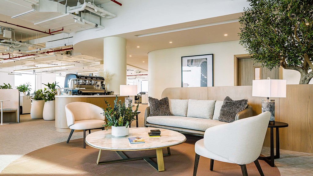 A living room with a couch and chairs.