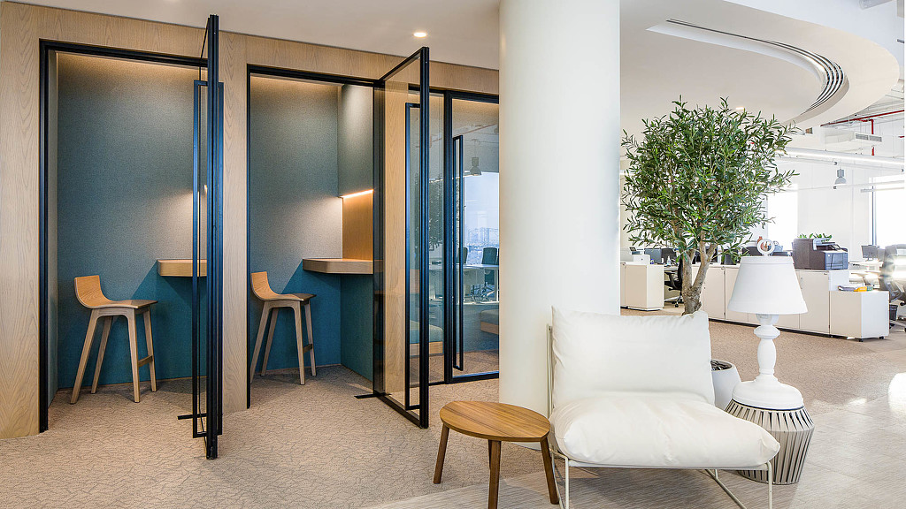 A room with glass doors and a tree.