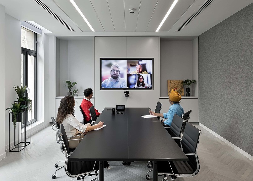 Employees in a hybrid meeting in No. 4 Gensler Birmingham conference room