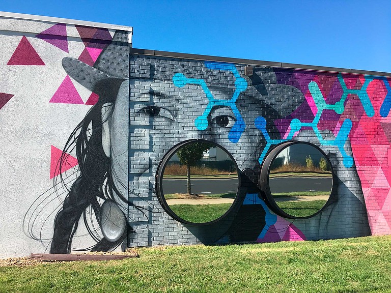 CBI Art Wall public mural of face with 3D binoculars