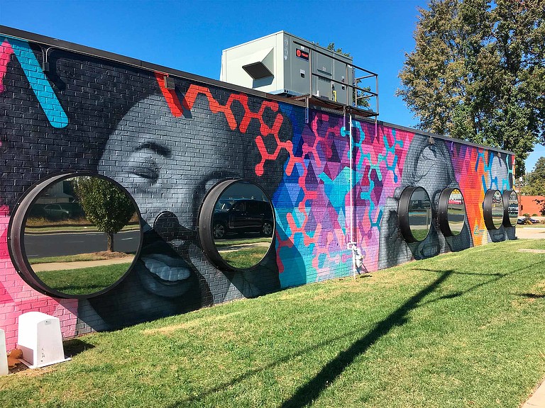CBI Art Wall public mural of faces with 3D binoculars