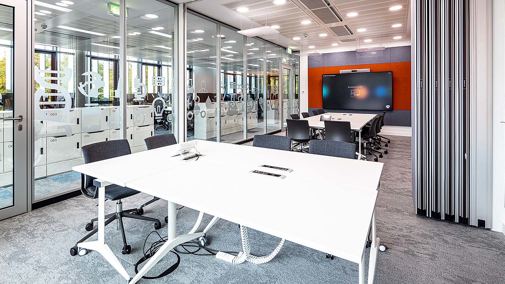 A conference room with a large screen.