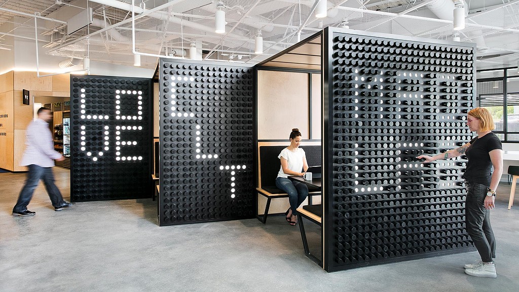 People in a room with large machines.