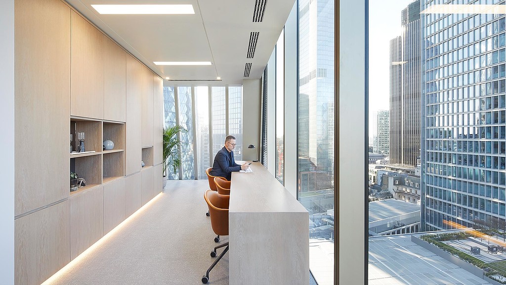 Man sitting at Sidley Austin London window table