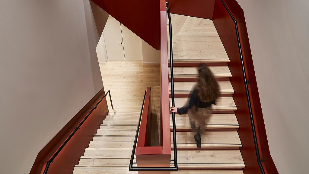 Woman walking up Storey 100 Liverpool Street staircase