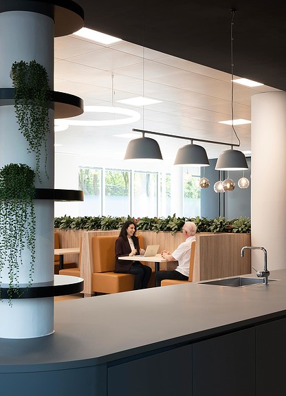 Two employees meeting at cafe-style booth at Citrix Cambridge