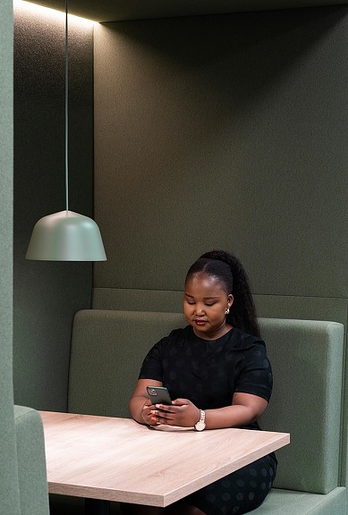 Woman sitting in Citrix Cambridge cafe-style booth