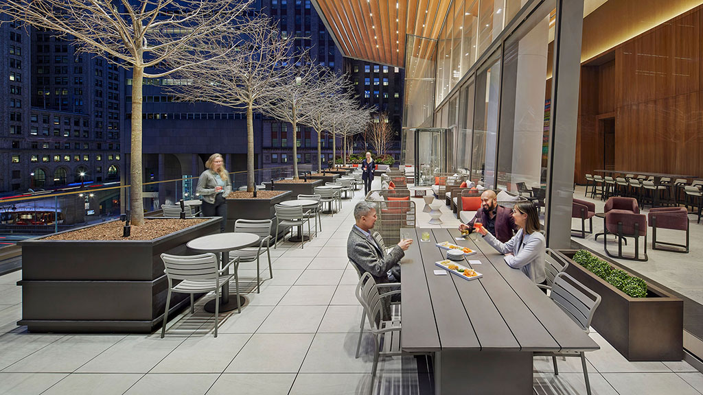 People sitting at tables outside.