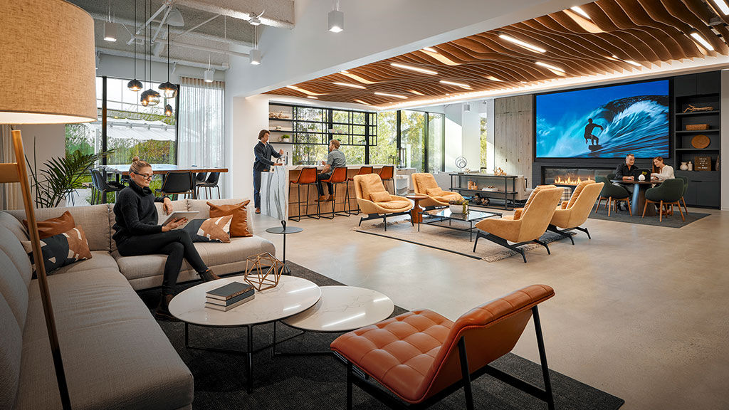 A room with a large screen and chairs.