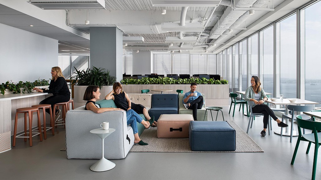 Employees socializing in Citrix Sydney office lounge area