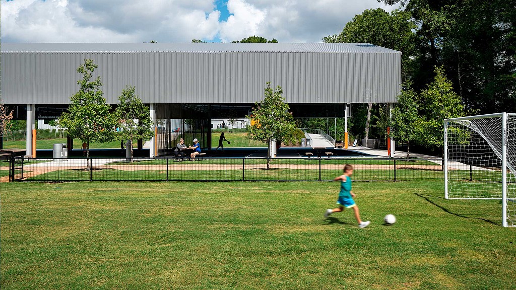 Boy playing soccer on Holcomb Family YMCA outdoor soccer field