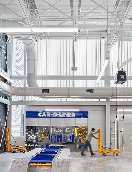 A person walking in a large warehouse.