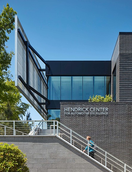 A person walking up stairs to a building.