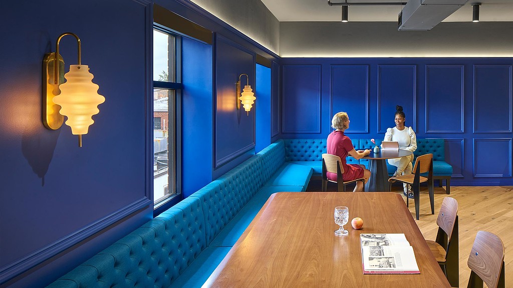 Oxford Finance cafe with steel-blue walls and banquet seating