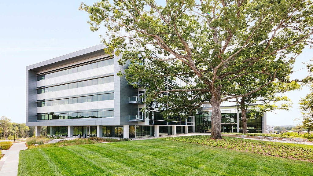 A large building with a tree in front of it.