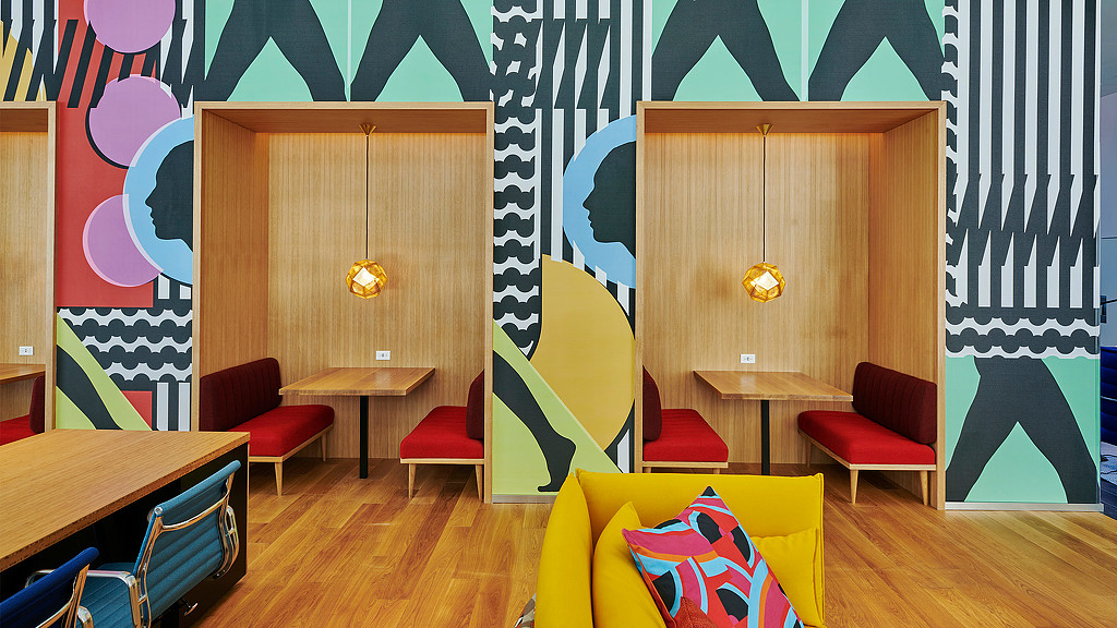 citizenM NoMa hotel lobby booth seating and wall art.