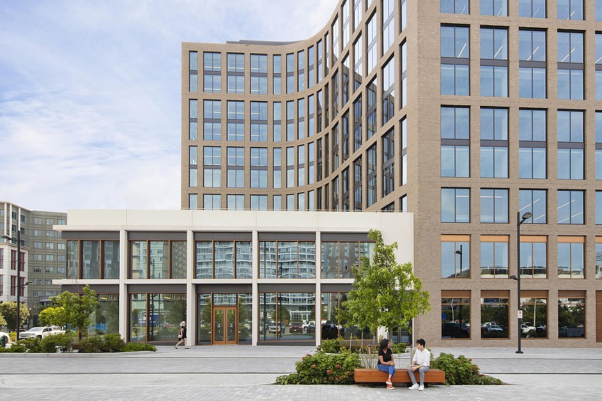 A building with people sitting on the bench.