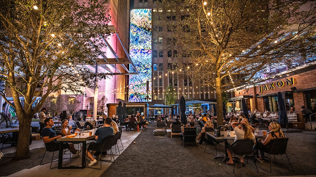 People sitting at tables outside.