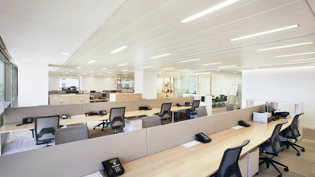 An empty office with a large desk.