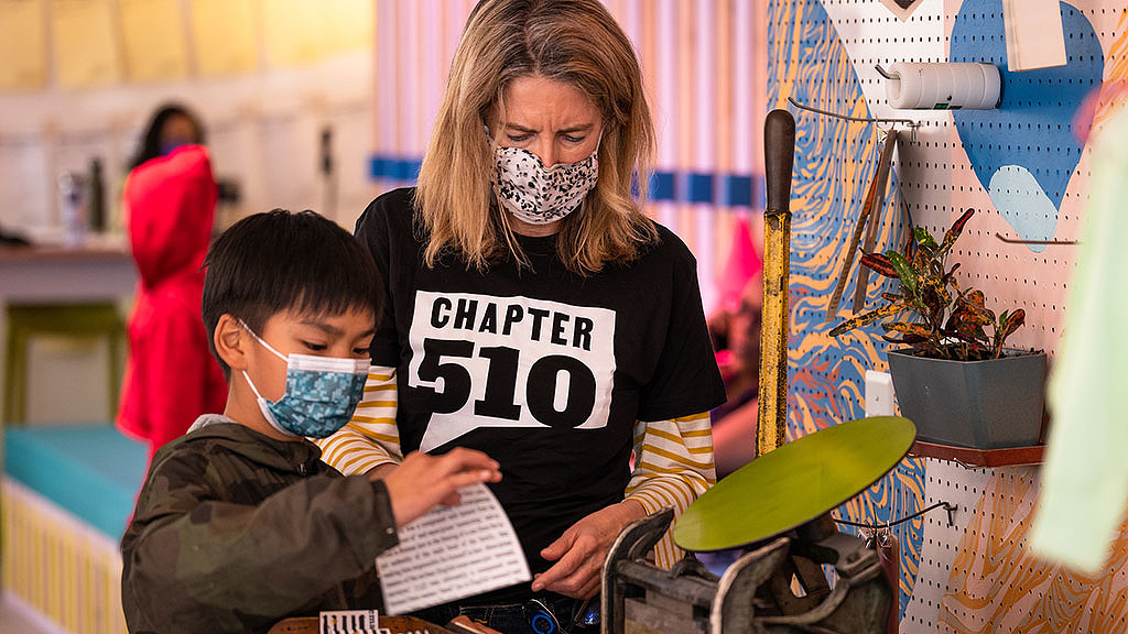 A person and a boy with paint on their faces.