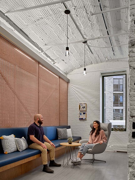 A man and woman sitting in Shady Grove Fertility Brooklyn waiting area.