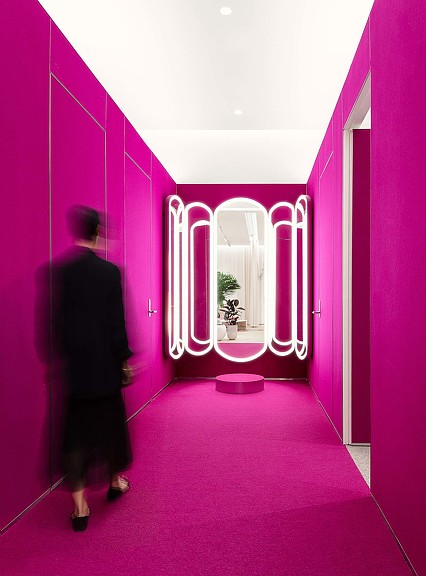 Magenta hallway with mirror in Holt Renfrew The Studio