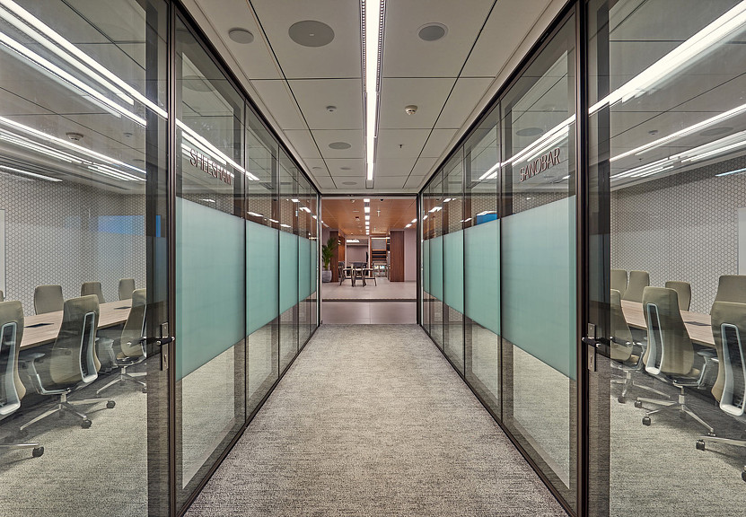 Financial services firm hallway between glass meeting rooms