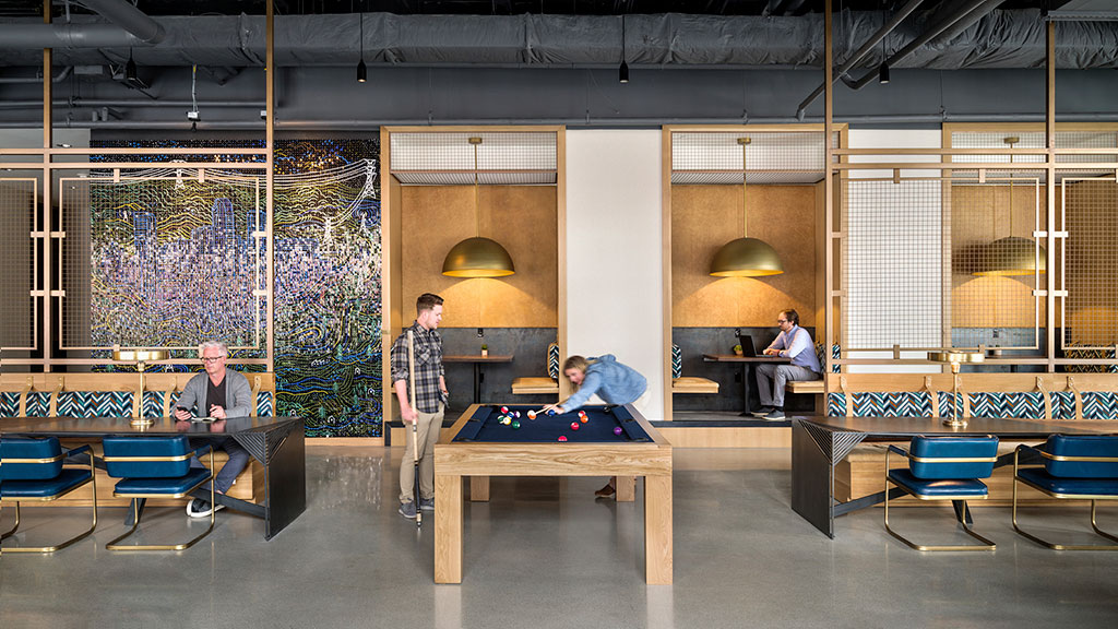 A group of people playing ping pong in a room with a large window.