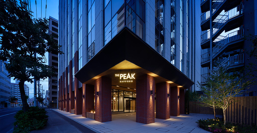 The Peak Sapporo office building exterior at night