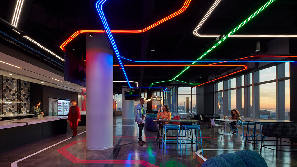 A group of people in a room with bright lights.