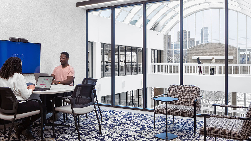 A meeting space overlooking an indoor atrium