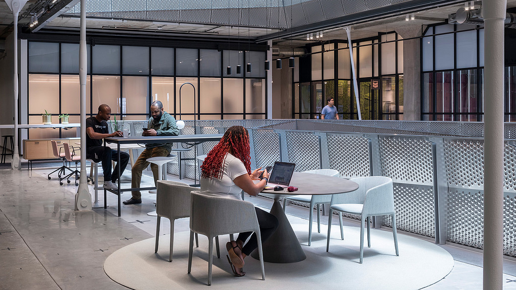People working at tables inside the Ion