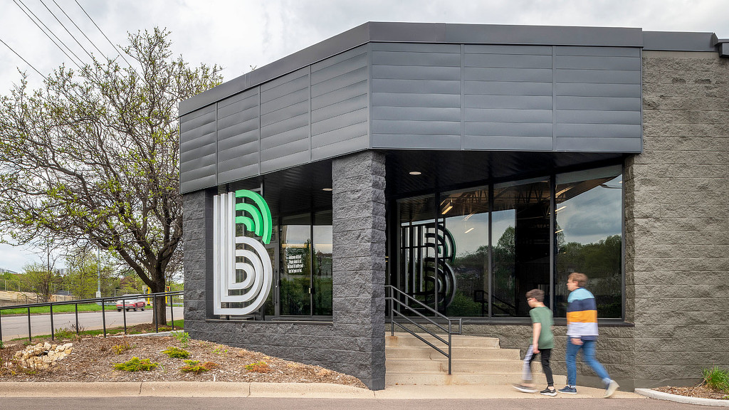 A couple of kids walking out of a building.