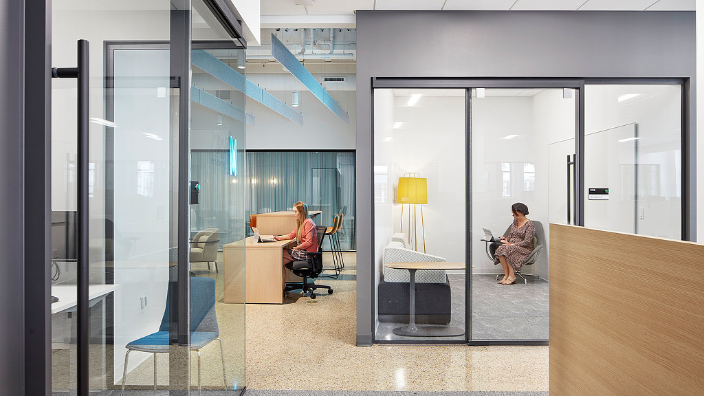 A modern office with glass doors and open infrastructure at Minneapolis Chamber of Commerce