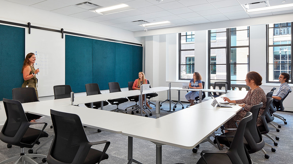 A group of people sitting around a table.